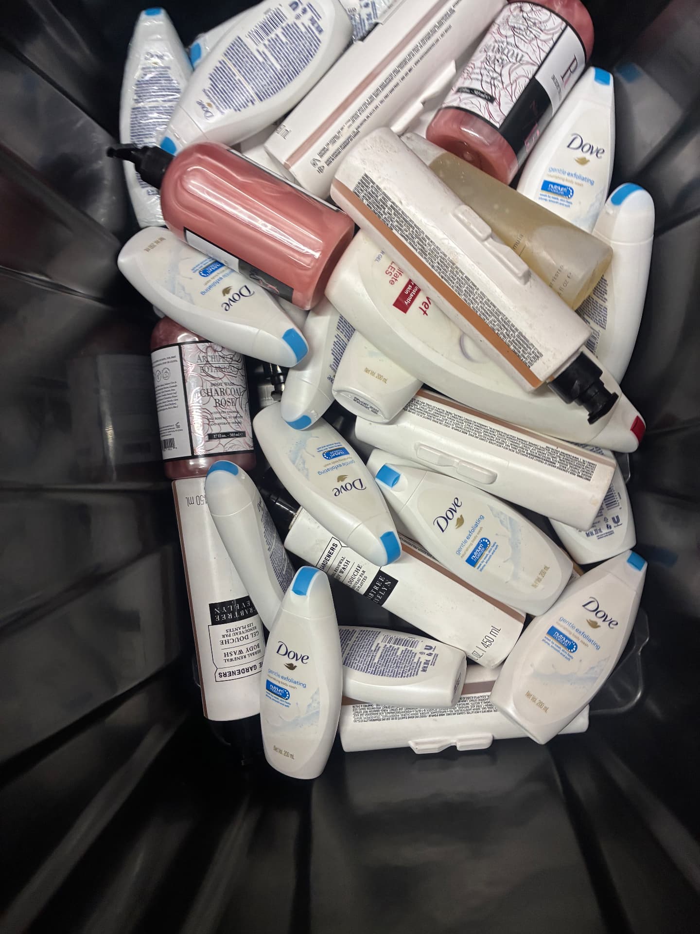 A bin full of donated body wash and lotion bottles collected by Harvest Her